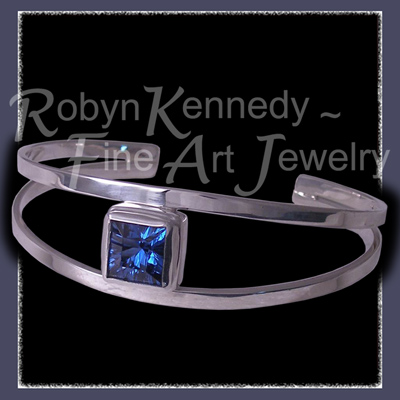 Sterling Silver and Fantasy Cut Glacier Blue Topaz 'Arctic Star' Bangle Bracelet Image