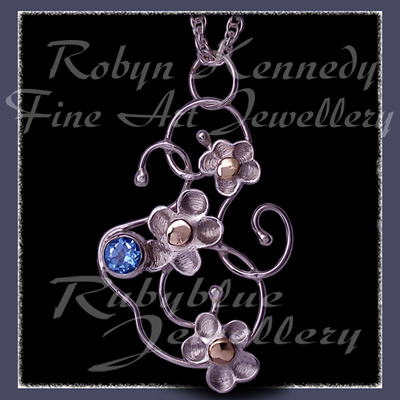 10 Karat Yellow Gold, Sterling Silver & Sky Blue Topaz 'Feeling Groovy'  Pendant Image