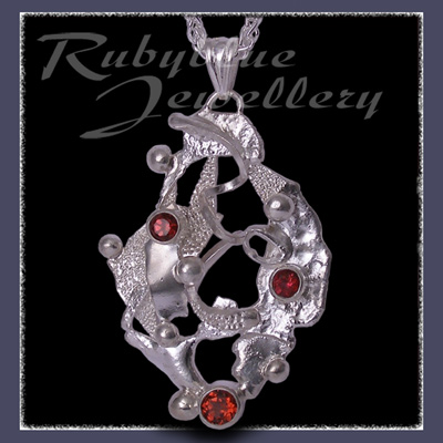 Sterling Silver, Rhodolite Garnet, Red Topaz & Mozambique Garnet 'Phoenix' Pendant Image